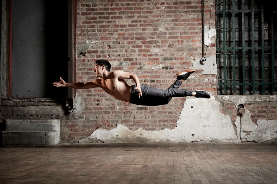 Alex Wong flying horizontally across a brick loft