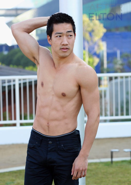 Alex Wong outdoors with one arm behind his head